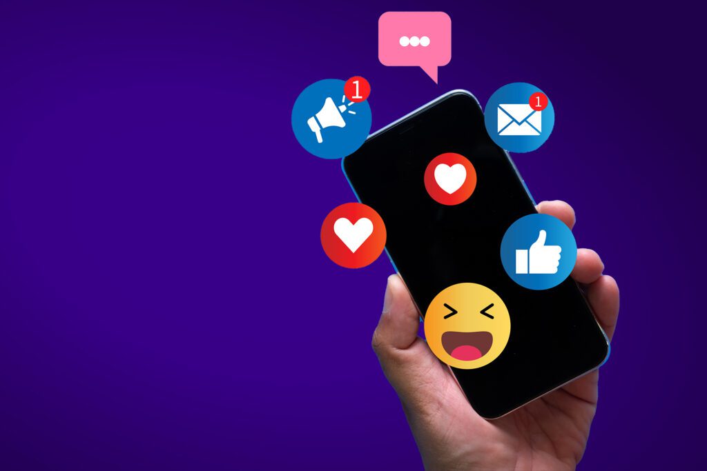 Hand holding smartphone with social media notifications, likes,