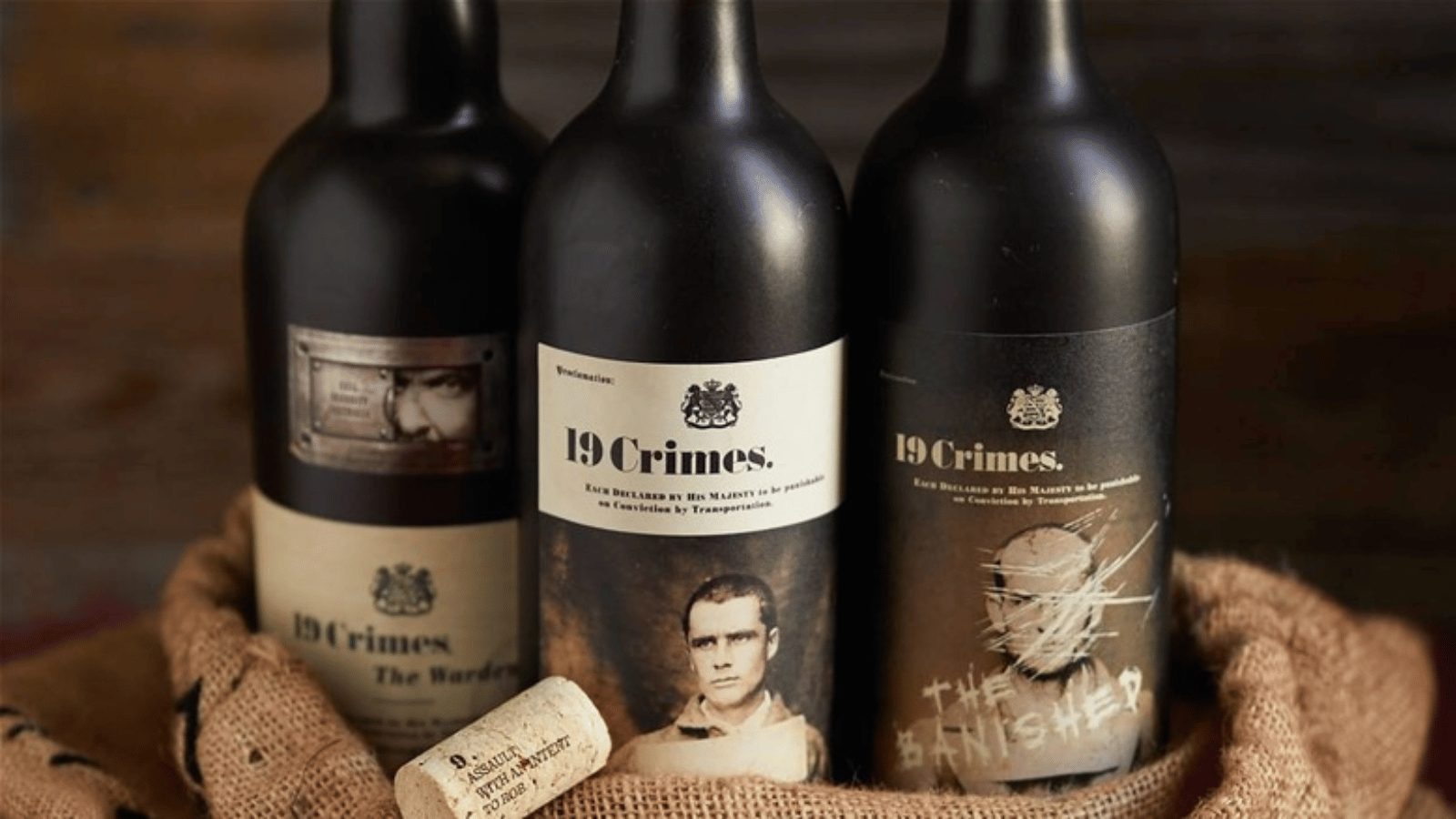 Three black bottles of red wine next to eachother