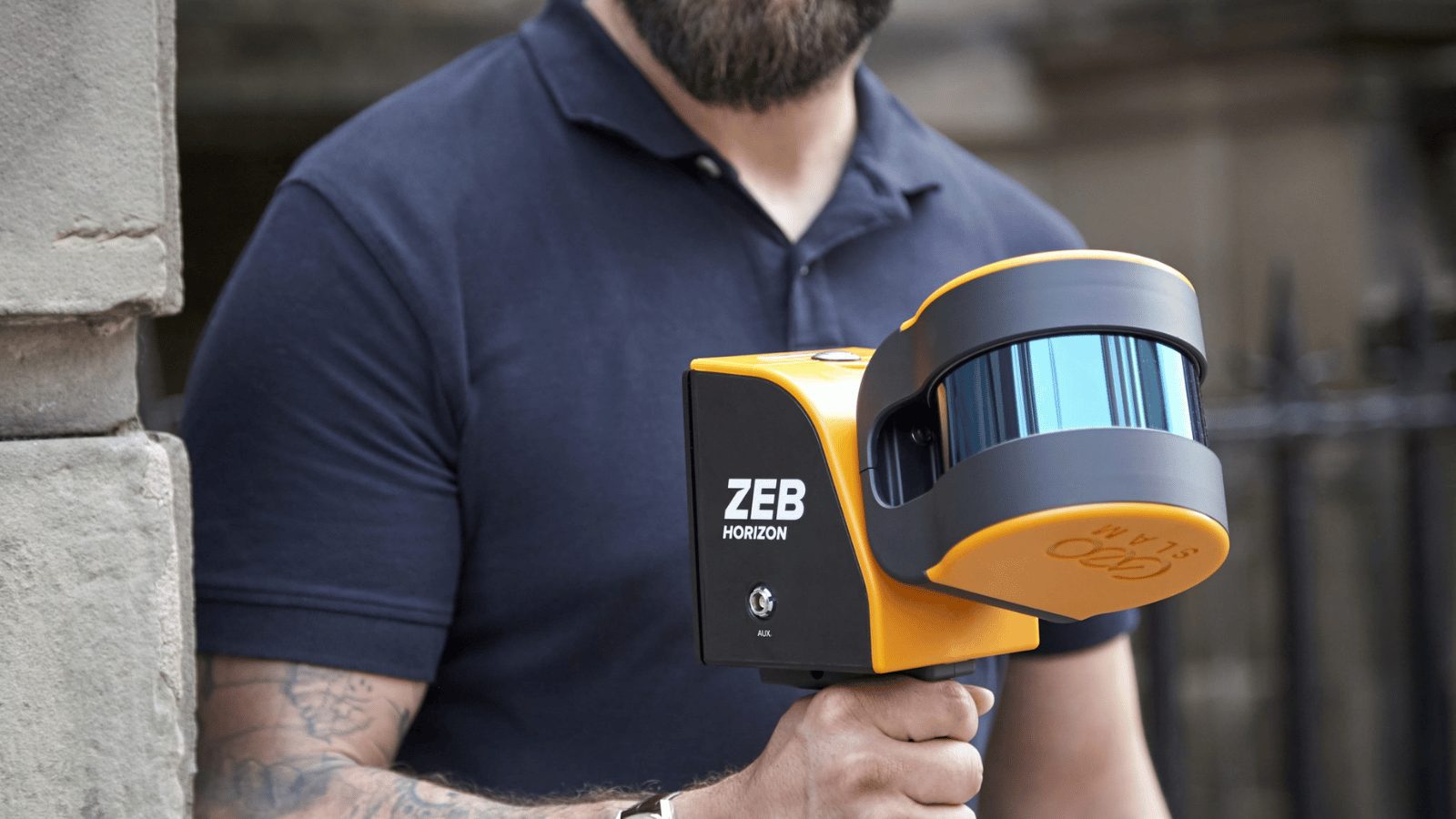 Man holding a handheld laser scanner.